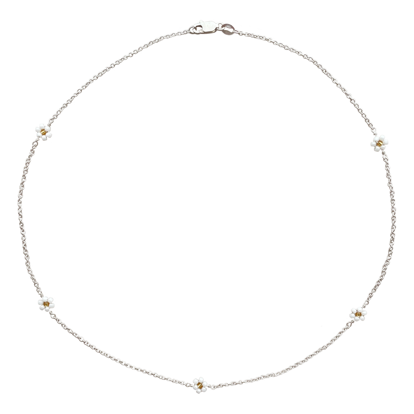 A thin silver necklace made with sterling silver cable chain, featuring 5 daisies spaced evenly. Each flower has 6 white petals and a gold centre.